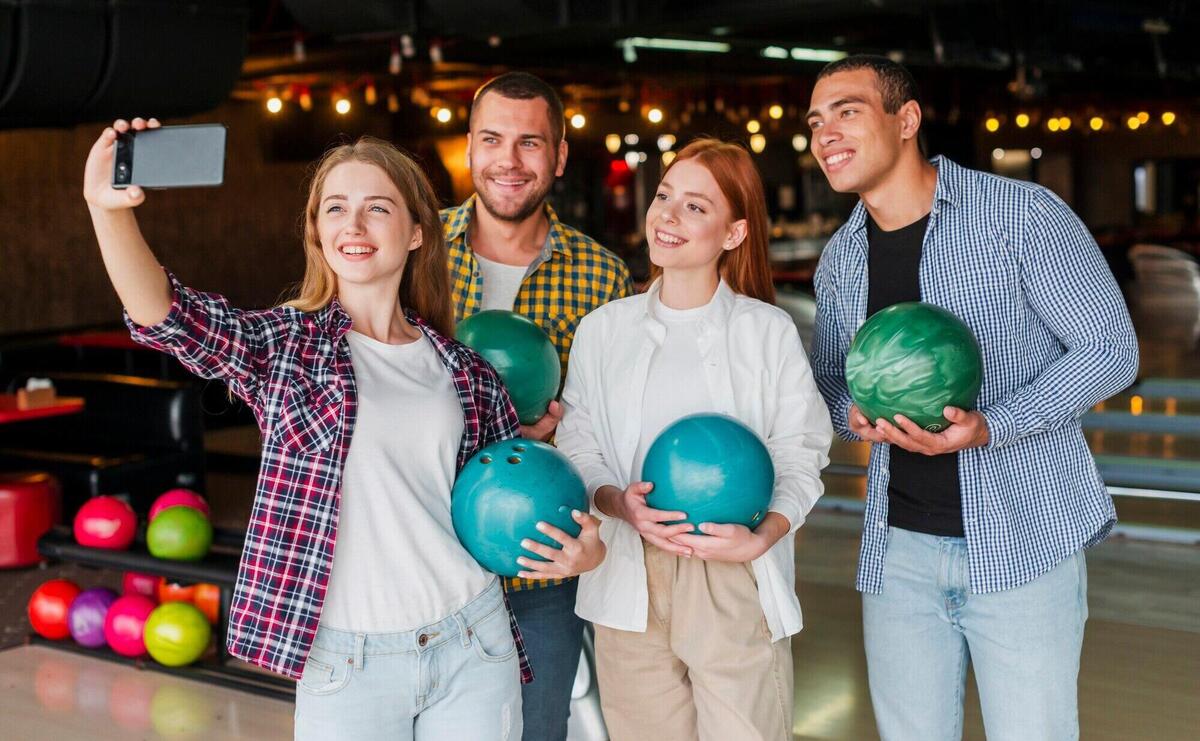 Friends holding colorful bowling balls