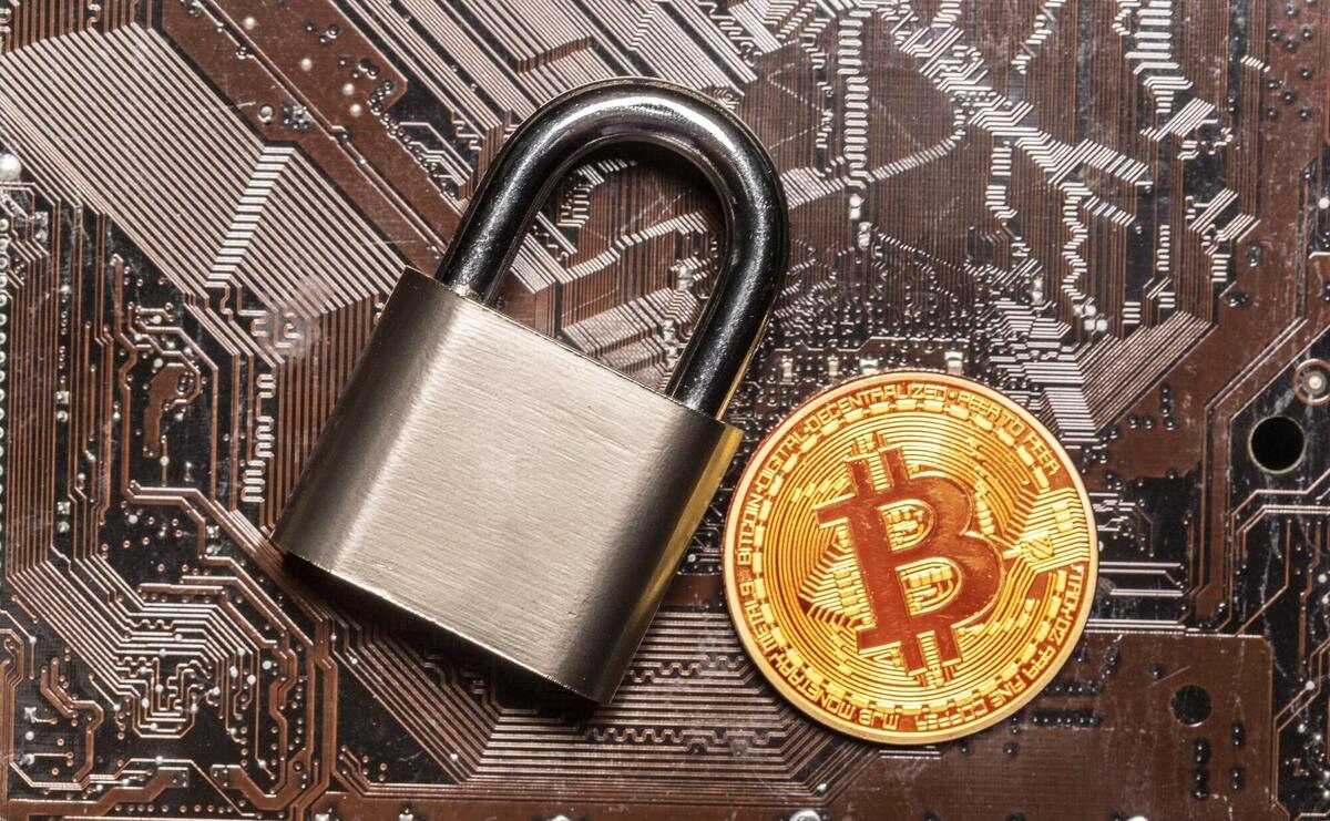 Gold bitcoin and padlock