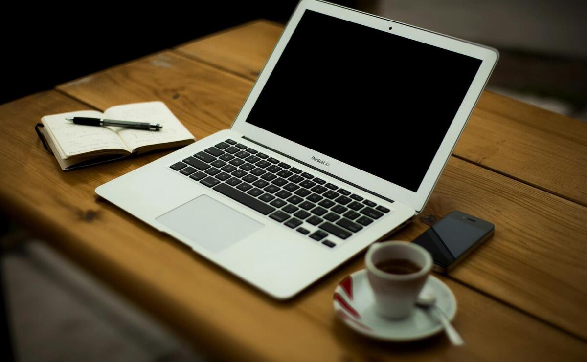 MacBook Air on brown wooden table