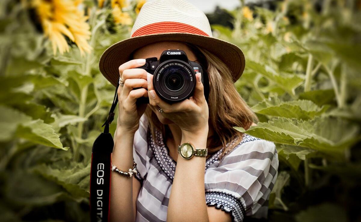 Selective Focus Photography of Woman Holding Dslr Camera