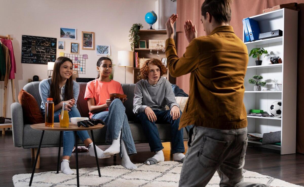 Group of teenage friends playing games at home together