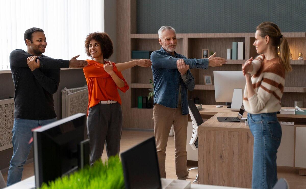 Colleagues at the office stretching during a work day