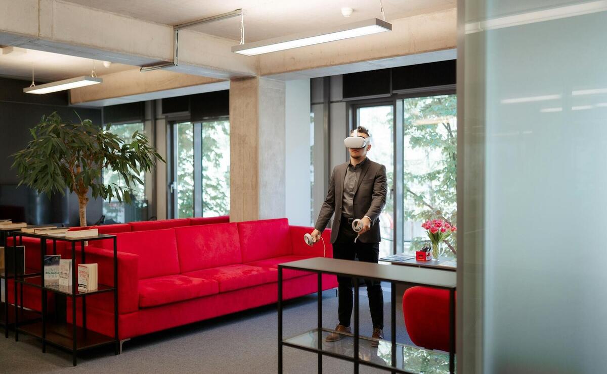 a man standing in a room with a red couch