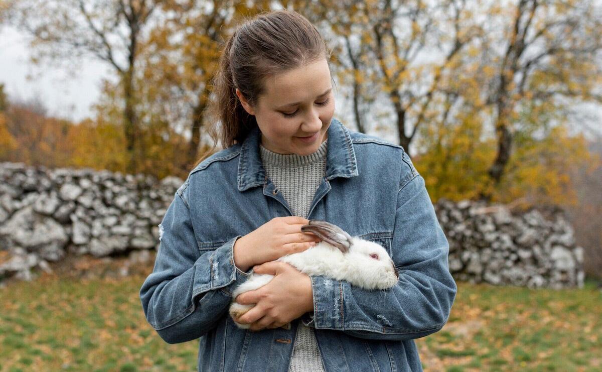 High angle woman caring rabbit