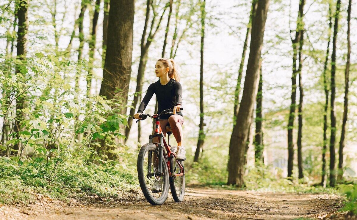 Woman riding a mountain bike in the forest