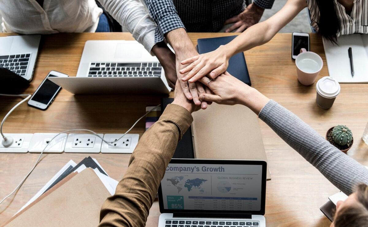 Team of business people stacking hands