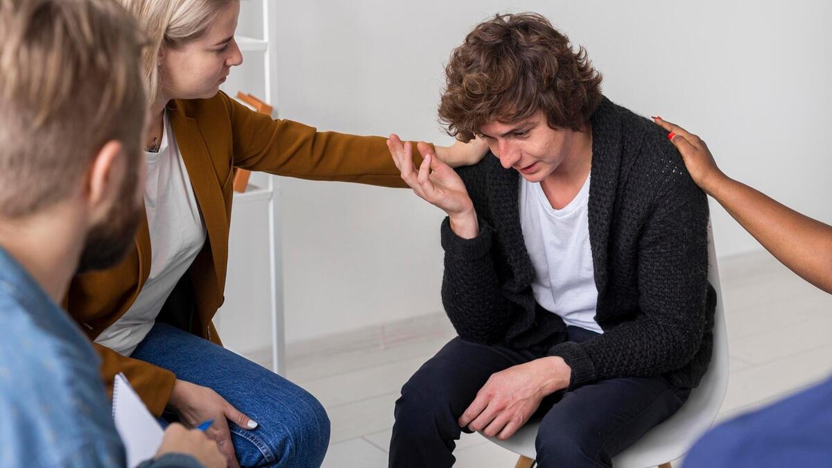 Community helping sad man close-up