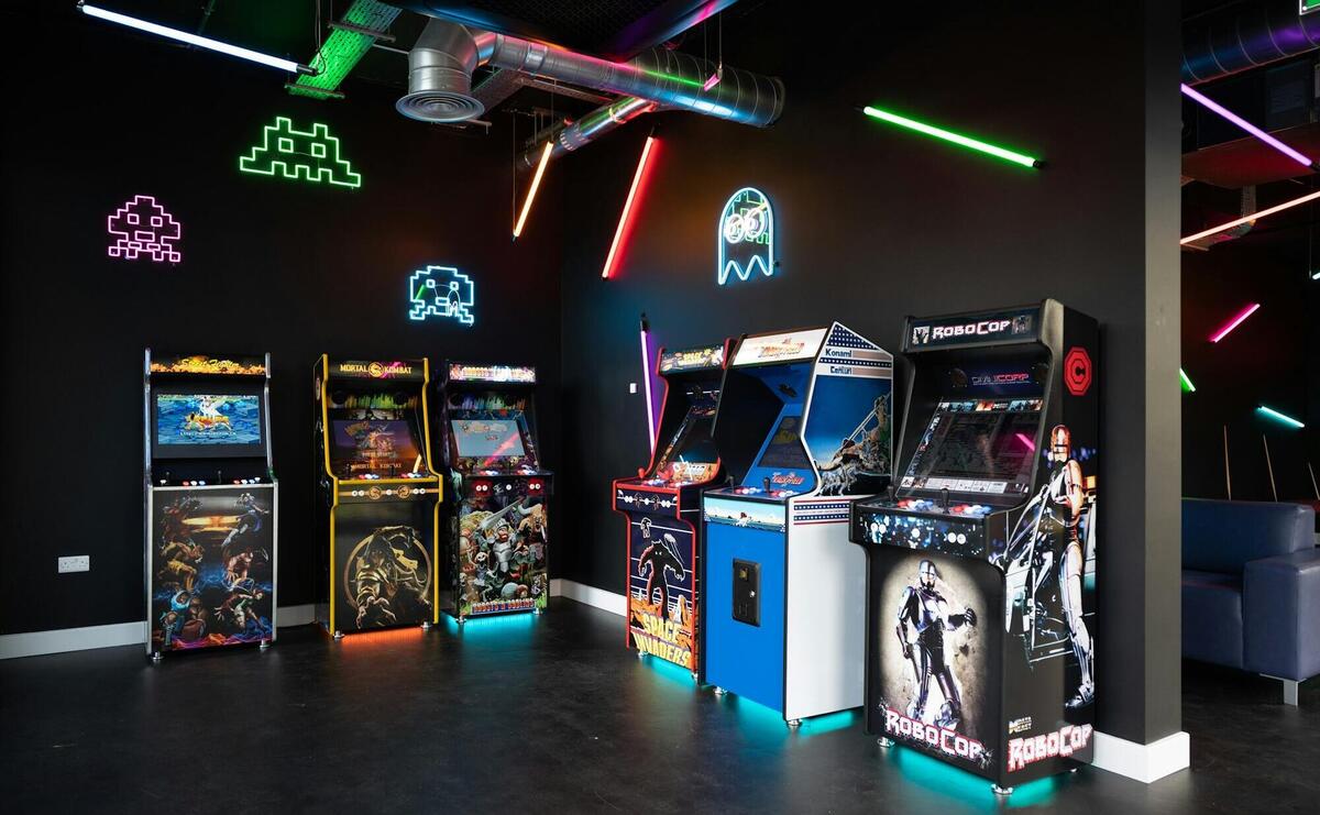 a room filled with arcade machines and neon lights