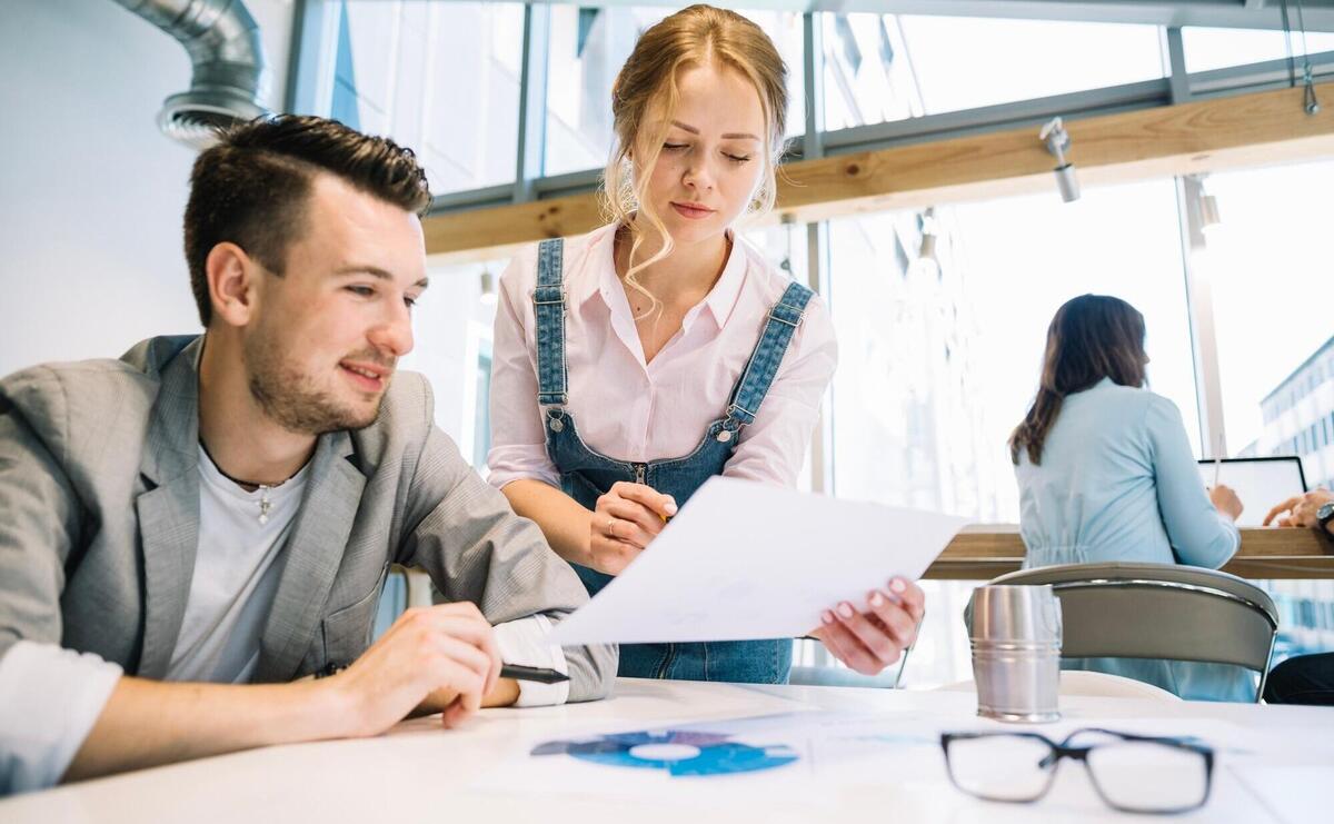 Collaborating man and woman with papers