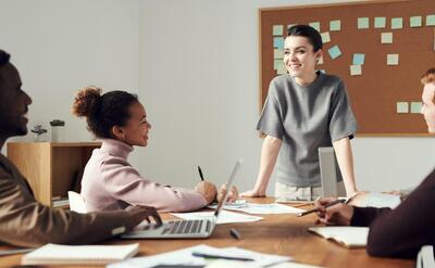 Business team collaborating in a modern office setting with diverse colleagues.