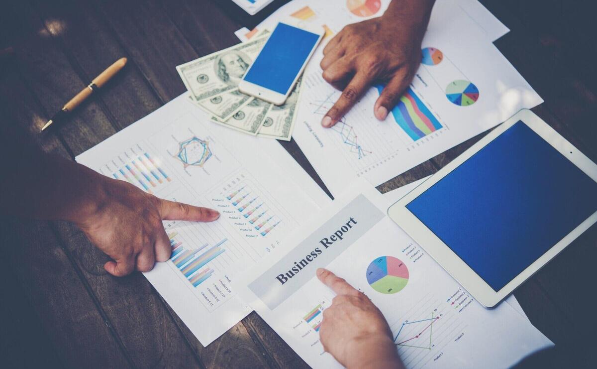 Group of business people analysis with marketing report graph, Young specialists are discussing business ideas for new digital start up project.