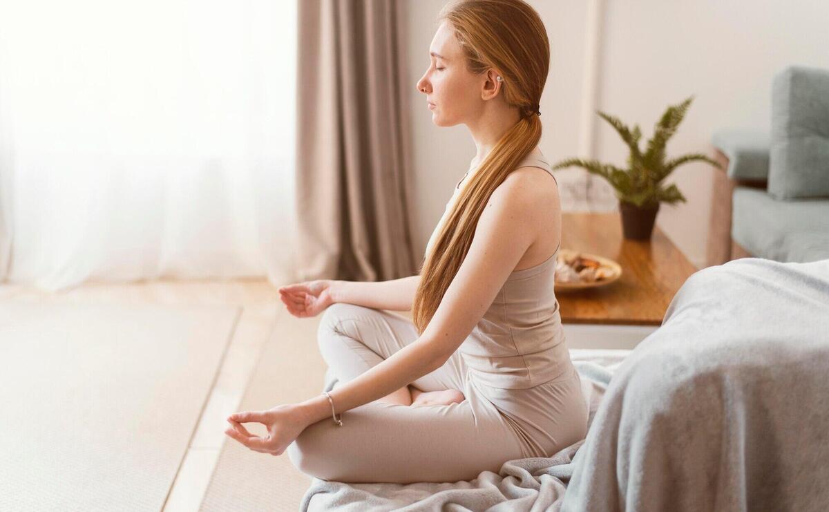 Side view young woman meditating at home