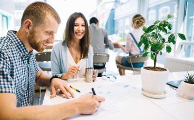 Cheerful coworkers with papers