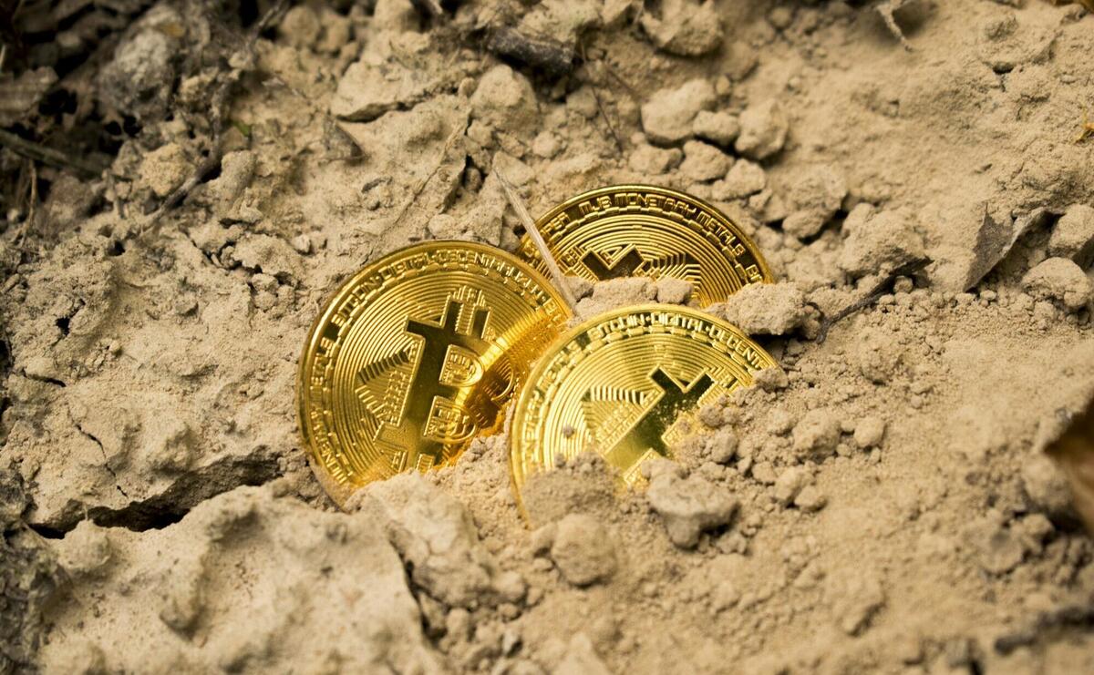 three Bitcoins on soil