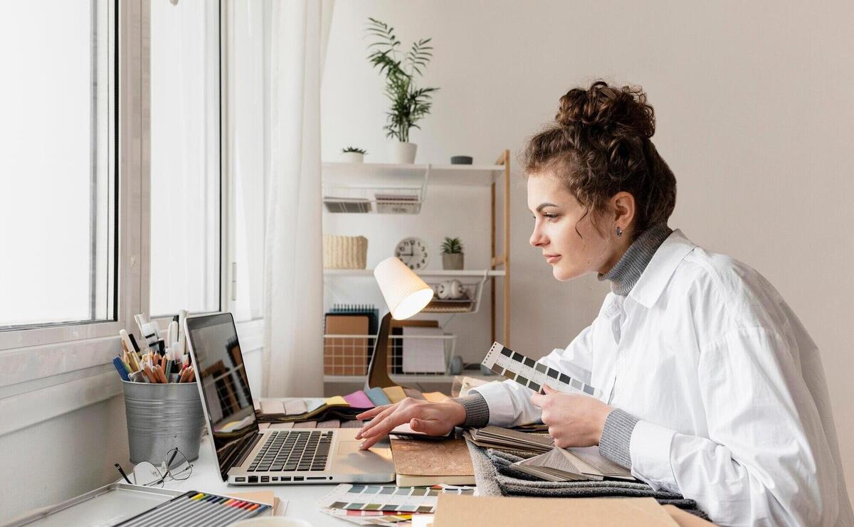 Medium shot woman working with laptop