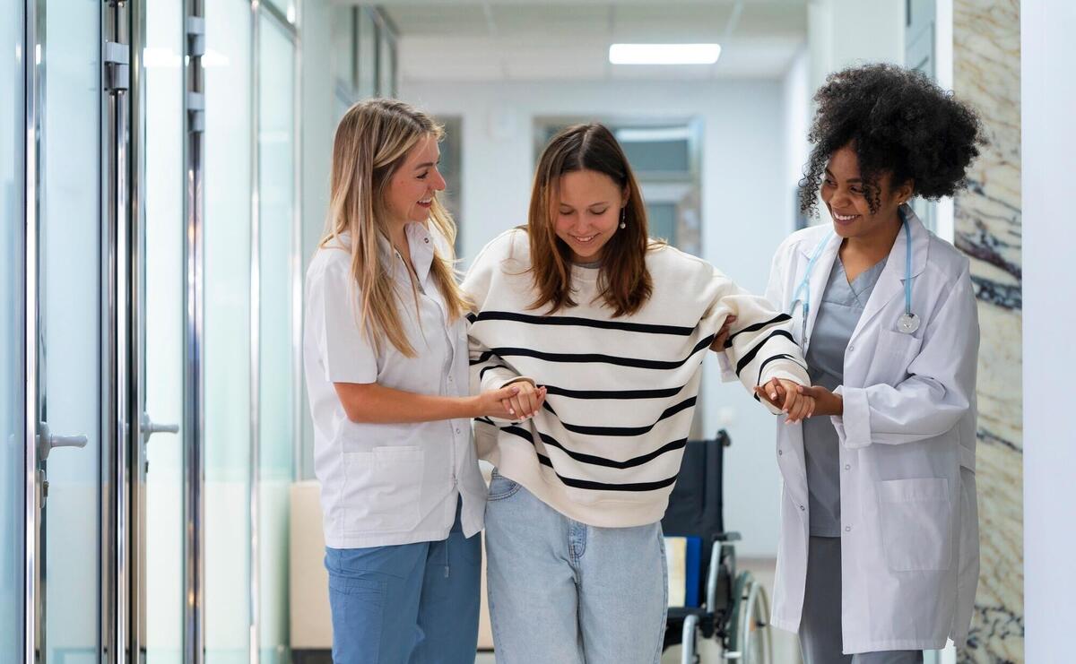 Front view female doctors helping patient