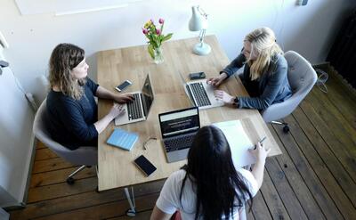 three women sitting and facing each other