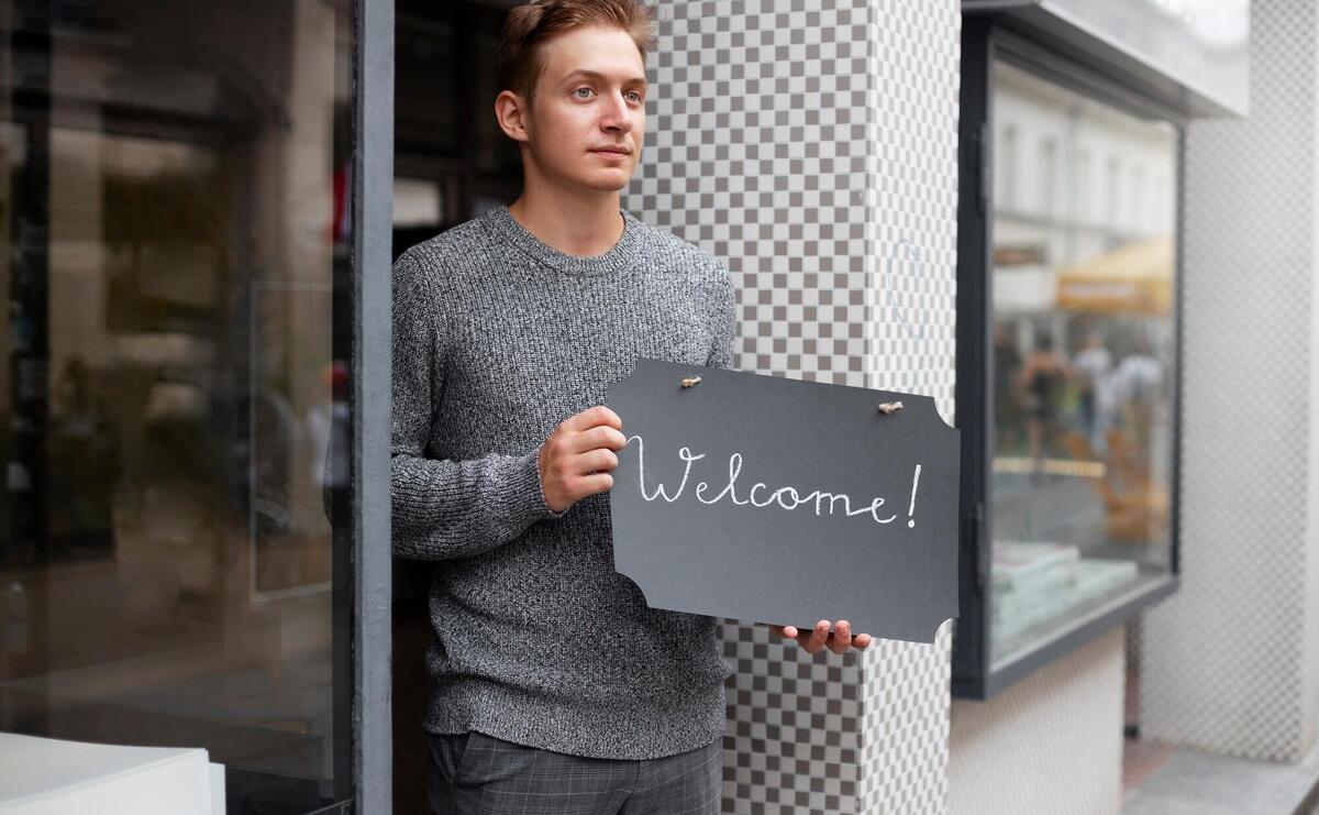 Medium shot man holding welcome sign