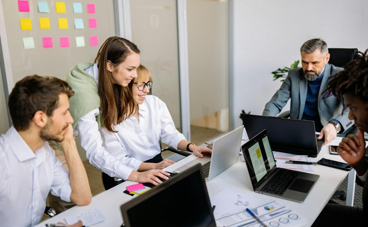 Diverse team of business professionals collaborating in a modern office setting.