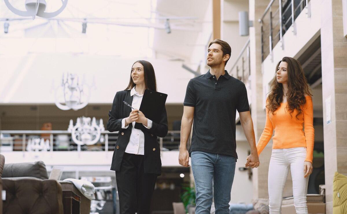 Couple with salesman in furniture store