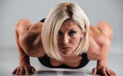 Close up portrait of a confident muscular adult sportwoman